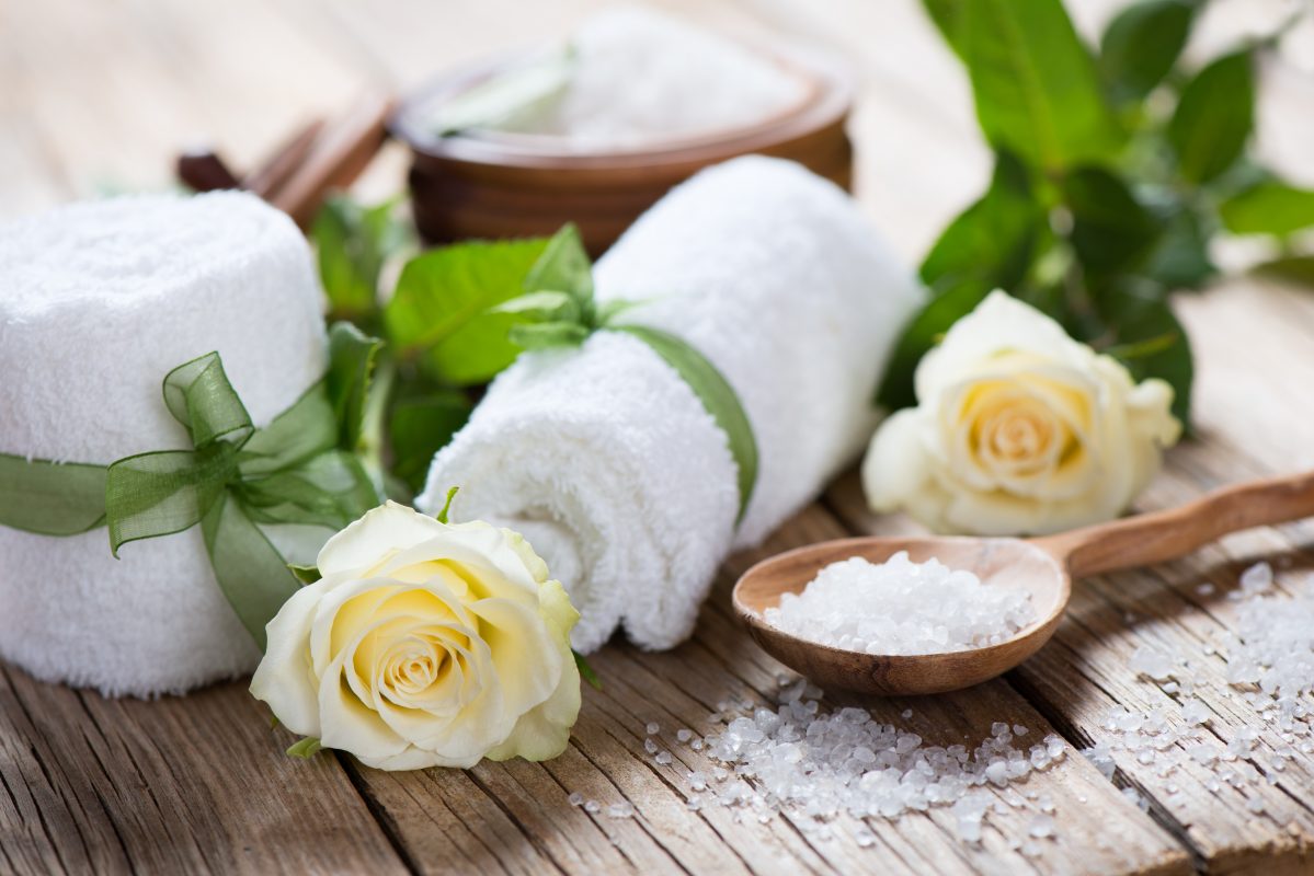 Aroma spa with roses on a old wooden background